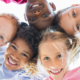 youth grief and bereavement services capacity building grants; young children huddled and smiling at camera