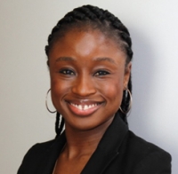 gun violence: Ruth Abaya (headshot), smiling woman with dark hair, earrings, black top