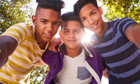 California: Concept of racism and integration. Portrait of happy boys smiling
