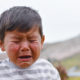 neglect: Little latino boy crying outdoors