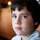 child sex abuse prevention grants; young sad boy looking into camera