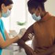 local community-based COVID vaccine access grants: Young African American woman getting vaccine