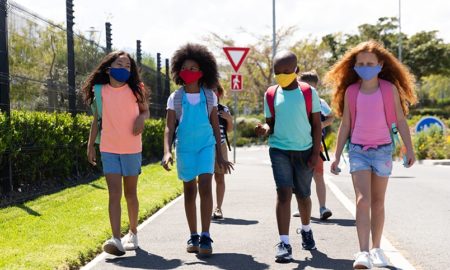 pandemic-caused math and reading learning loss grants: group of students go to school with masks on