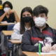 schools make few changes for new year: students in masks sitting at desks
