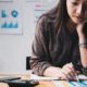 education research and career grants: young Asian woman doing research on desk