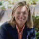 Amy Freitag to be president of New York Community Trust: white woman in blazer sitting and leaning forward while smiling outside
