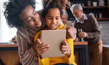 responsible innovation in technology for children report: mother and daughter having fun on tablet together