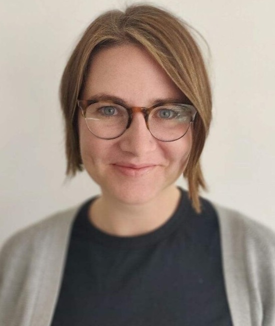 Students with disabilities expert Jessica Gingold headshot: white woman in glasses with short brown hair smiling against white-grey background