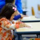 Pittsburgh area grants to address learning loss: young Asian girl working at school desk