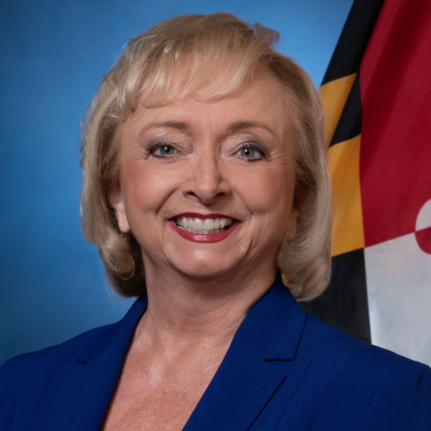 Disabled student programs DOGE cut: Headshot blonde woman in Navy suit and white top