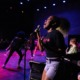 Well-being and well-becoming through the arts_A picture of mattering for youth of color: young black woman singing on stage passionately